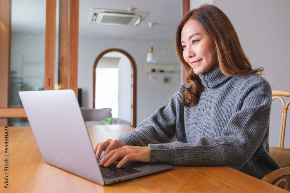 Portrait image of a young woman working on laptop computer at home Portrait image of a young woman working on laptop computer at home