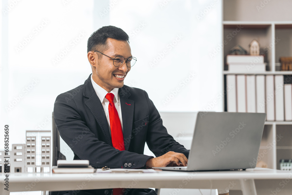 Agent presents contracts for property purchase or lease. Businessman asian indian people showcases miniature model home, signifying secure property insurance. Desk scene in a home sales office. Agent presents contracts for property purchase or lease. Businessman asian indian people showcases miniature model home, signifying secure property insurance. Desk scene in a home sales office.
