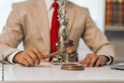 Wallpaper Mural Middle-aged Asian indian people male lawyer meticulously reviews legal documents. Courtroom judge hammer and goddess scales. Depicting the essence of legal counseling and comprehensive services. Torontodigital.ca