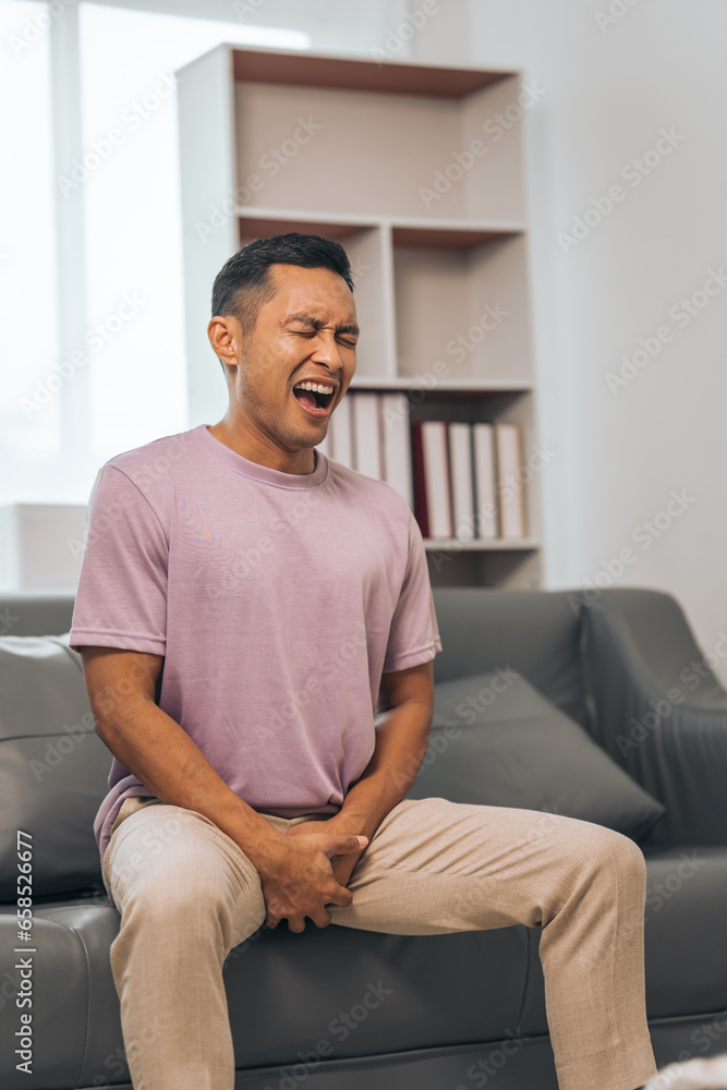 Prostate cancer and men's health, Middle-aged Asian Indian man grappling with testicular discomfort. Vivid portrayal of male health challenges, urging awareness and timely medical consultations. Prostate cancer and men's health, Middle-aged Asian Indian man grappling with testicular discomfort. Vivid portrayal of male health challenges, urging awareness and timely medical consultations.