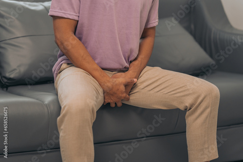 Prostate cancer and men's health, Middle-aged Asian Indian man grappling with testicular discomfort. Vivid portrayal of male health challenges, urging awareness and timely medical consultations.