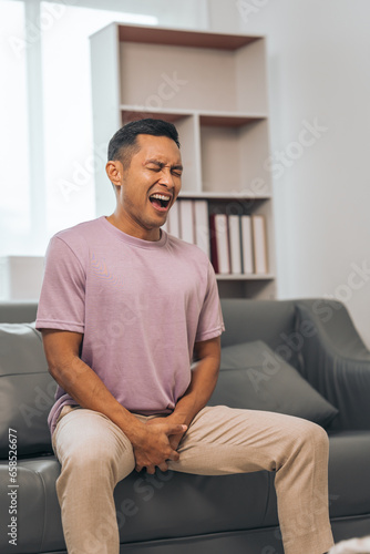 Obraz na plátně Prostate cancer and men's health, Middle-aged Asian Indian man grappling with testicular discomfort