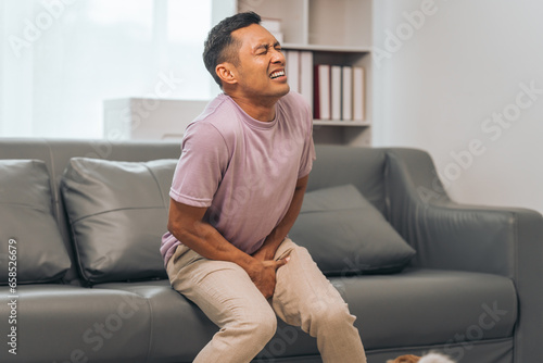 Obraz na plátně Prostate cancer and men's health, Middle-aged Asian Indian man grappling with testicular discomfort