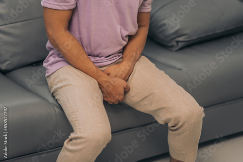 Prostate cancer and men's health, Middle-aged Asian Indian man grappling with testicular discomfort. Vivid portrayal of male health challenges, urging awareness and timely medical consultations.