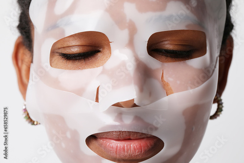 Close-up of woman applies a hydro gel face mask. Skin care and beauty treatments