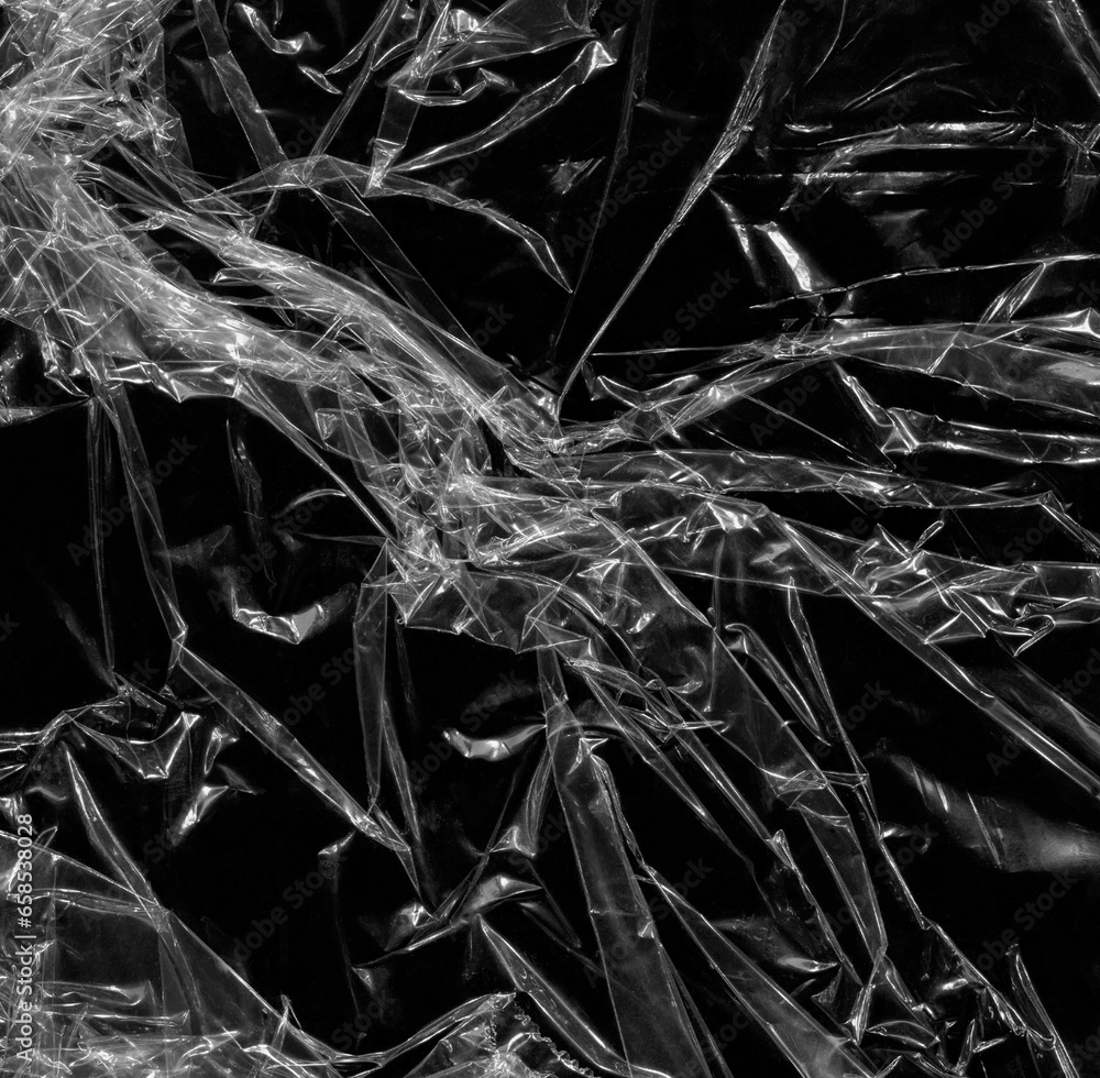 Wrinkled plastic wrap texture on a black background wallpaper. Royalty high-quality free stock photo image of realistic plastic wrap for overlay, copy space and photo effect. Wrinkled plastic surface Wrinkled plastic wrap texture on a black background wallpaper. Royalty high-quality free stock photo image of realistic plastic wrap for overlay, copy space and photo effect. Wrinkled plastic surface