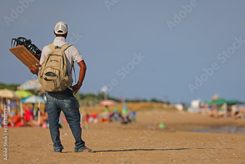 Fototapeta Naklejka Na Ścianę i Meble -  illegal hawker in the beach by the sea in summer