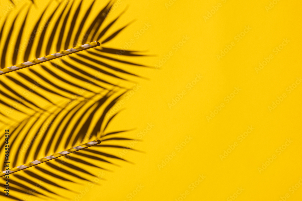 Obraz premium Top View of Colorful Tropical Leaves and Straws on Yellow Background: Summer Exotic Flat Lay with Copy Space and Border Decoration