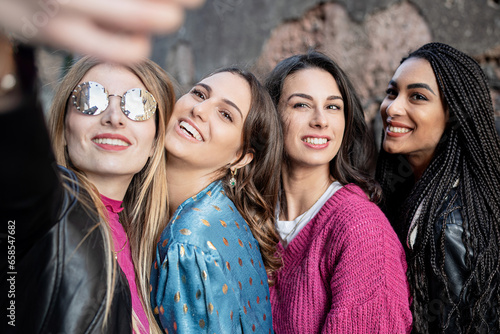 Young Women Taking a Selfie in Old City - Four friends in the historic town, capturing a moment of joy and camaraderie. © Lomb