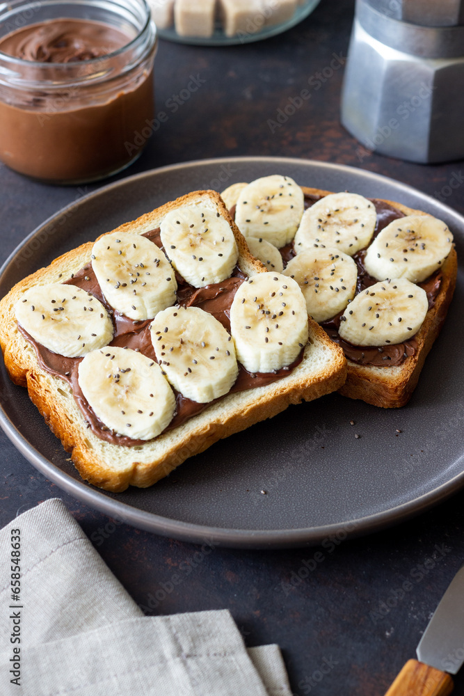 Sandwich with chocolate paste, banana and chia seeds. Breakfast. Vegetarian food. Sandwich with chocolate paste, banana and chia seeds. Breakfast. Vegetarian food.
