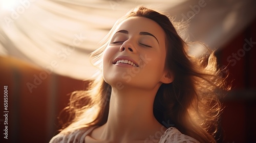Happy young woman feeling relaxed with eyes closed. Smiling woman stretching with hands forward feeling fresh on a bright morning. Beautiful girl stretch herself in the morning photo
