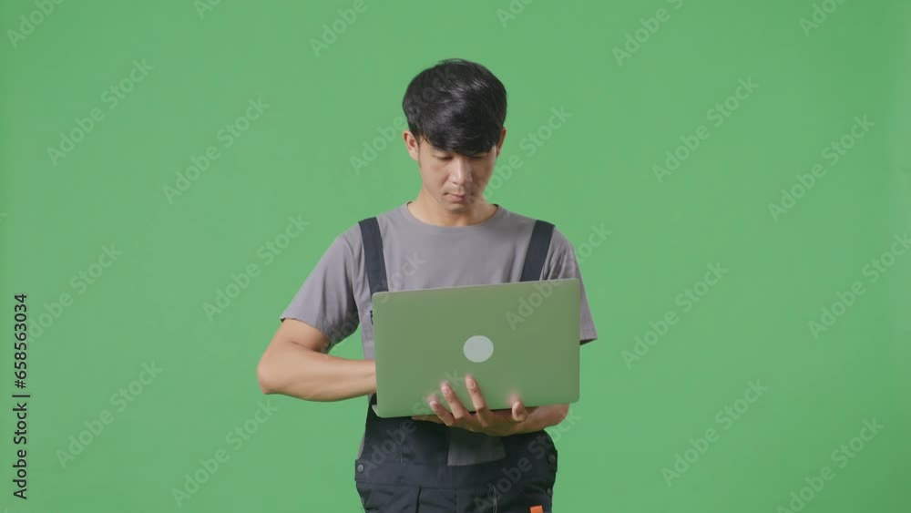 Asian Man Worker Using A Laptop While Walking In The Green Screen Background Studio
Asian Man Worker Using A Laptop While Walking In The Green Screen Background Studio