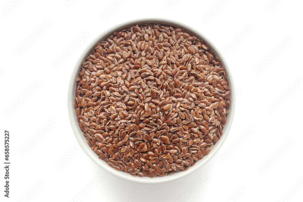 Organic Flaxseeds (Linum usitatissimum) in a white ceramic bowl. Isolated on a white background. Top View Organic Flaxseeds (Linum usitatissimum) in a white ceramic bowl. Isolated on a white background. Top View