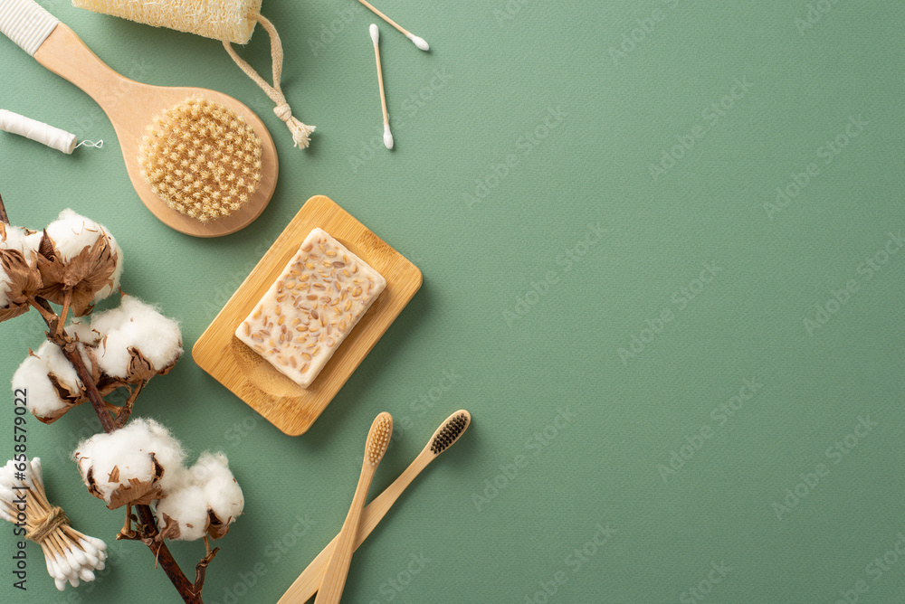 Green Living Collection: Top view of eco products like bamboo toothbrushes, wooden massage brush, buds, dental floss, cotton plant and handmade soap on a serene green background for your promotion - obrazy, fototapety, plakaty 