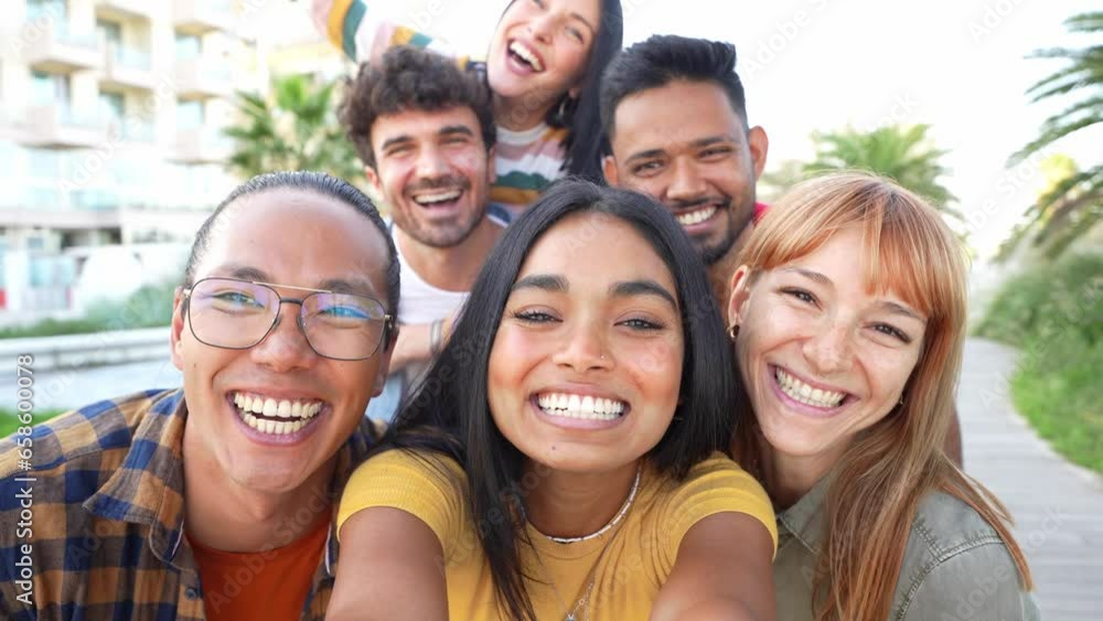 Multiracial friends taking selfie video with smart mobile phone outside - Happy young people having fun talking on city street - Life style concept with guys and girls hanging out on a sunny day Multiracial friends taking selfie video with smart mobile phone outside - Happy young people having fun talking on city street - Life style concept with guys and girls hanging out on a sunny day