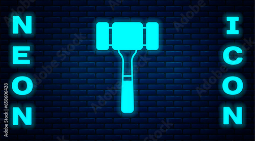 Glowing neon Auction hammer icon isolated on brick wall background. Gavel - hammer of judge or auctioneer. Bidding process, deal done. Auction bidding. Vector