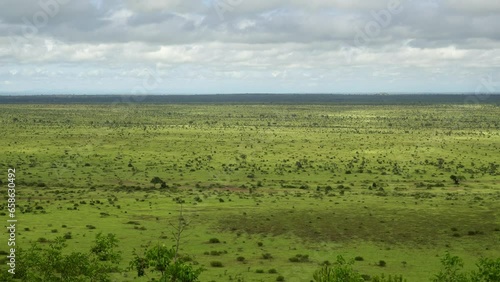 Static landscape of the vast African savannah with clouds and light wind photo