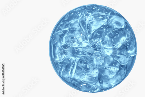 Transparent blue cosmetic gel in a round jar. View from above. On an light background.