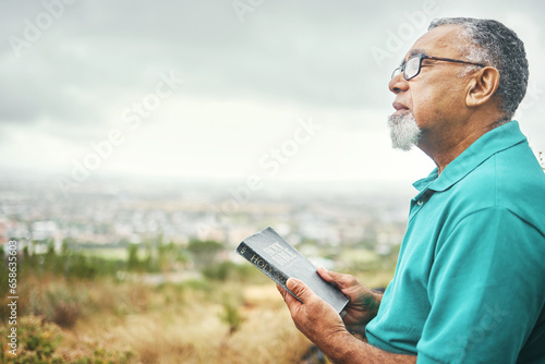 Bible, praying or senior man in nature for praise, hope or Christian religion with holy mindfulness. Prayer moment, calm pastor or mature person in worship with faith, spiritual and sky mockup © aLListar/peopleimages.com