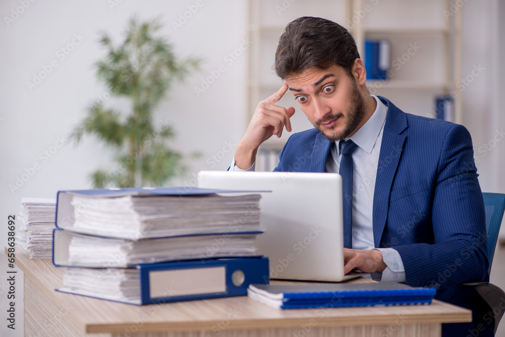 Young male employee working in the office Young male employee working in the office