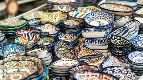Moroccan pottery with colorful ceramics and pottery displayed outside shops in the souks, or traditional markets.
