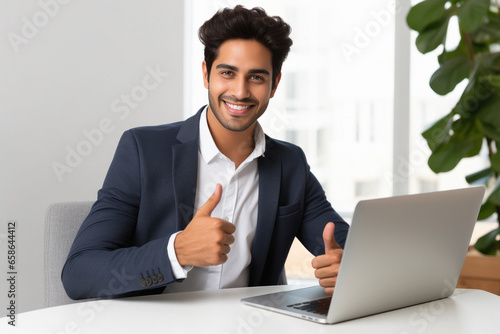 Young businessman showing thumps at office photo