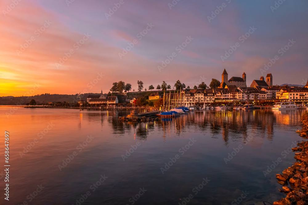 Beautiful sunset over the old harbor of Rapperswil, Canton St. Gallen, Switzerland.