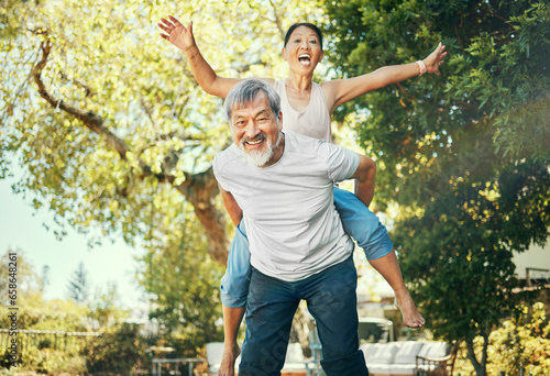 Couple, piggyback and nature to smile in portrait, excited and playful in freedom, energy and joy. Happy elderly asian people, face and date in summer, laughing and support for crazy in retirement