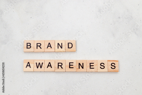 Top view of Brand Awareness word on wooden cube letter block on white background. Business concept © Yazid Nasuha