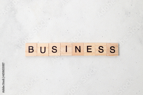 Top view of Business word on wooden cube letter block on white background. Business concept © Yazid Nasuha