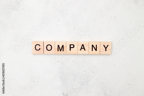 Top view of Company word on wooden cube letter block on white background. Business concept © Yazid Nasuha