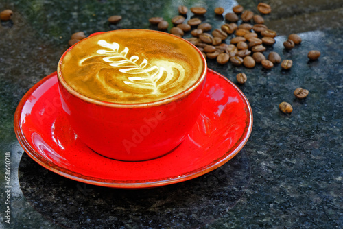 a cup of coffee, coffee beans and book