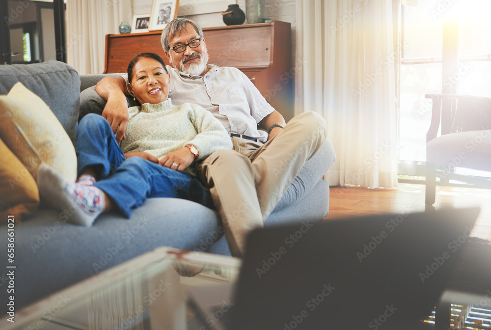 Senior couple watching a movie on sofa with laptop in the living room together for bonding. Happy, smile and elderly man and woman in retirement relaxing and streaming show or film in lounge at home.