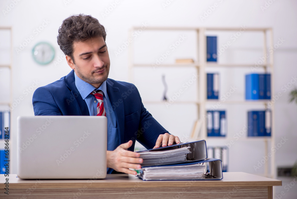 Young male employee working in the office Young male employee working in the office