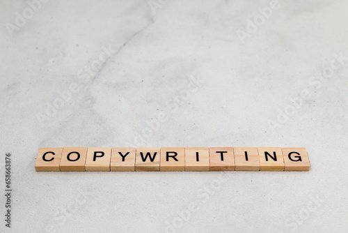 Top view of Copywriting word on wooden cube letter block on white background. Business concept