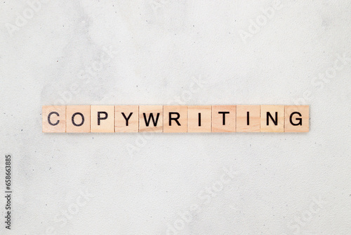 Top view of Copywriting word on wooden cube letter block on white background. Business concept © Yazid Nasuha