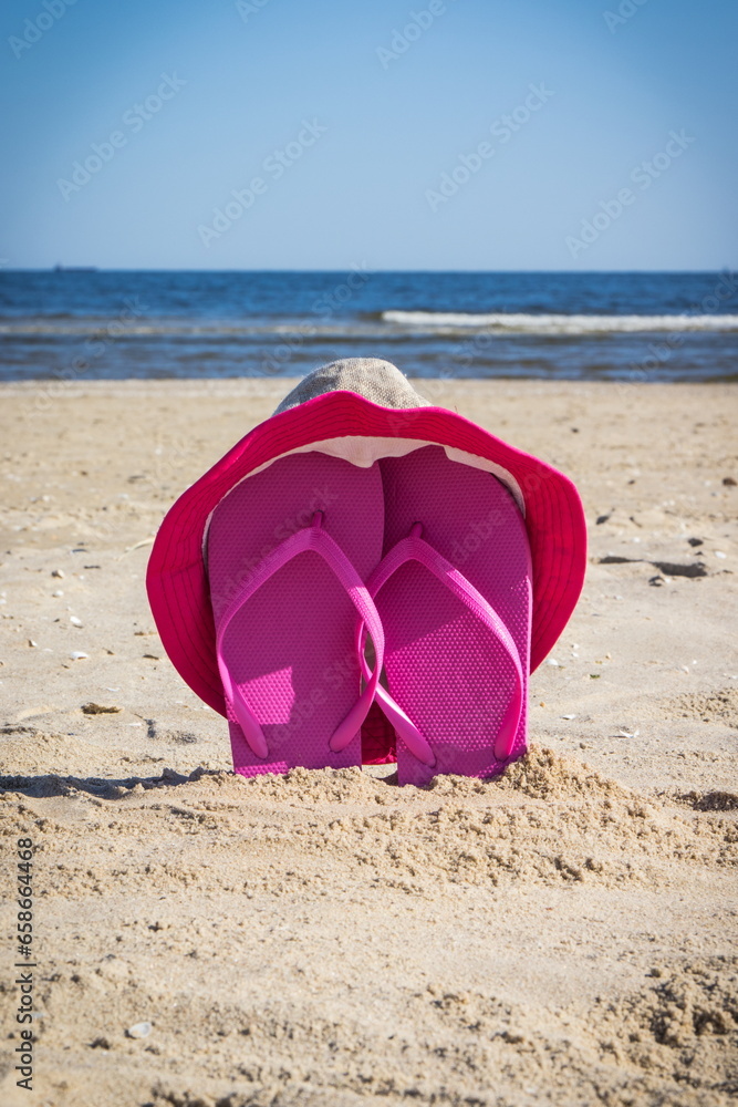Accessories for relax on beach. Straw hat and flip flop. Summertime Accessories for relax on beach. Straw hat and flip flop. Summertime