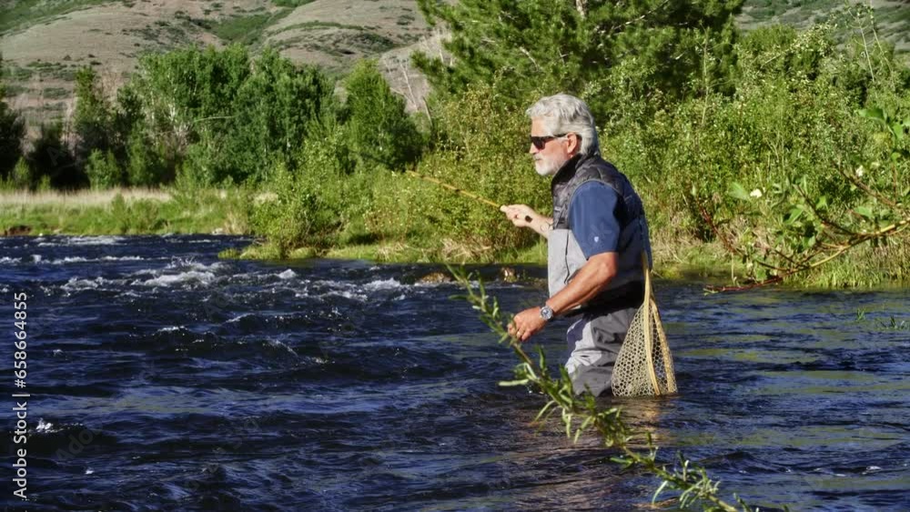 Fisherman Casting Line While Standing In River - Slow Motion Fisherman Casting Line While Standing In River - Slow Motion