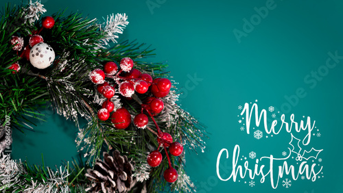 Christmas wreath and lettering with   merry christmas on turquoise background.Christmas banner. Minimalism. Copyspace. 