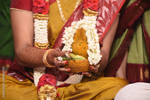 a bride holding thali in indian wedding ceremony
