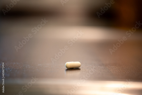 Single capsule with alpha lipoic acid on a kitchen counter