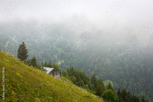 old chalet and foggy landscape in the background