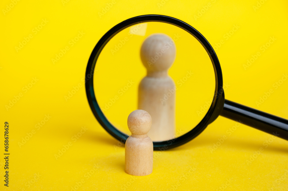 Wooden figure looking at the future him or her. Goal and motivation concept Wooden figure looking at the future him or her. Goal and motivation concept