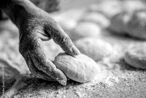 Womans hands rolling dough for pies. Baking at home. Homemade cakes dough in the women's hands. Process of making pies. Black and white