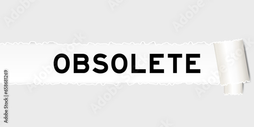 Ripped gray paper background that have word obsolete under torn part