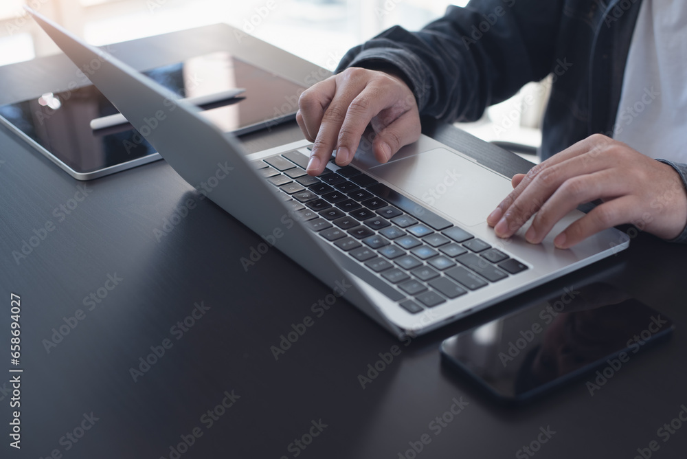 Business man hands typing on laptop computer keyboard and surfing the internet on office table, online working, business and technology, internet network concept Business man hands typing on laptop computer keyboard and surfing the internet on office table, online working, business and technology, internet network concept