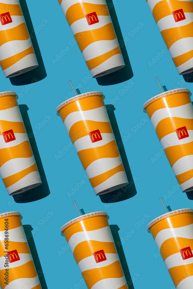 Yellow glass of McDonald's. Paper cup with lid. Takeaway drink ...