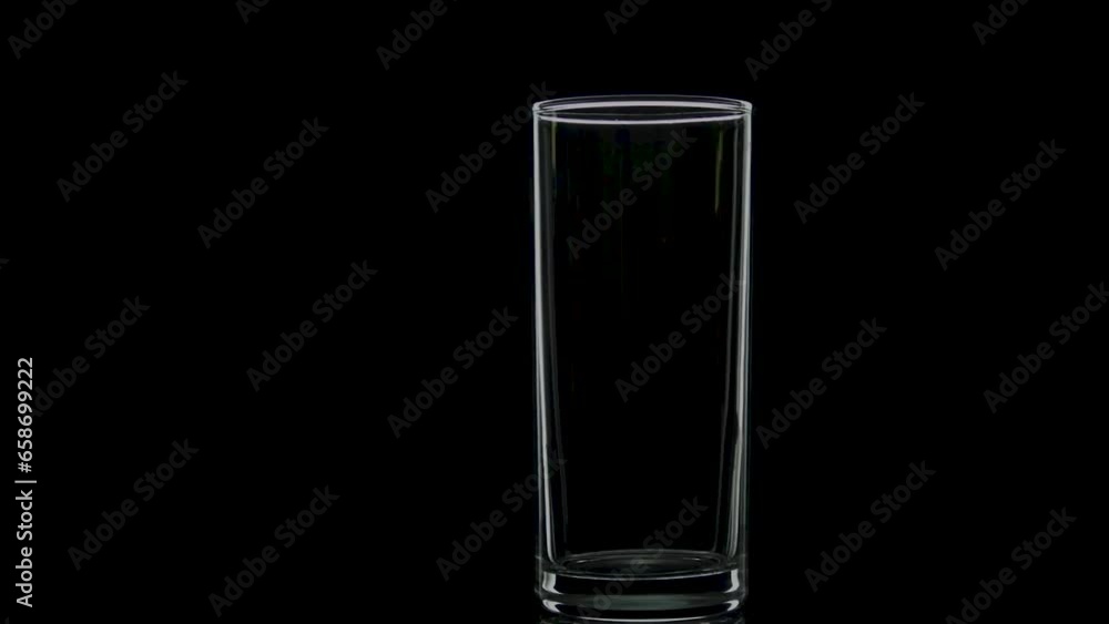 Glass cylindrical glass rotates in the dark in contour light Glass cylindrical glass rotates in the dark in contour light