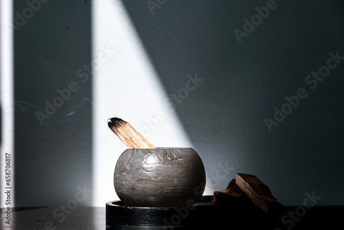 Palo Santo sticks on a light background.Aromatherapy religious rituals meditation.Wellness with aromatherapy and the occult.Healing incense Palo Santo.Organic incense of the holy ritual tree.Ibiokai photo