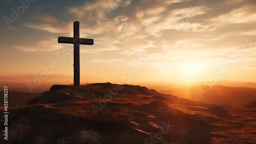 Wooden cross silhouette against a dramatic sunset sky on a hill, symbolizing hope and faith